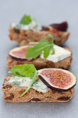 Tasty open sandwiches with fig fruits.