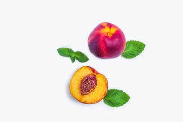 Halves of smooth-skinned ripe nectarines (peaches) with seed on a white background. Top view, flat lay, copy space for text.