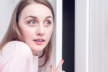 Pretty young girl overhears outside the door, portrait, close up, toned