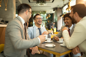 Funny conversation four businessmen while sit pub and drinking coffee after work