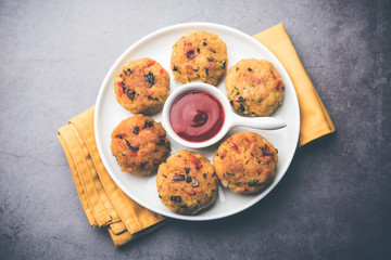 Veg Poha Cutlet or flattened Rice Patties served with tomato ketchup and green chutney