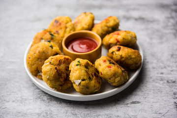 Veg Poha Cutlet or flattened Rice Patties served with tomato ketchup and green chutney