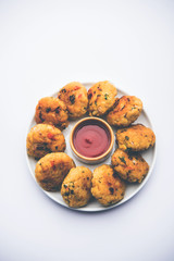 Veg Poha Cutlet or flattened Rice Patties served with tomato ketchup and green chutney