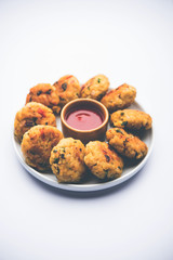 Veg Poha Cutlet or flattened Rice Patties served with tomato ketchup and green chutney