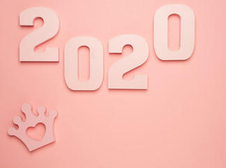 Creative inspiration concepts 2020 with text number and crown on the color background.Business resolution, action plan ideas.Pink color pale shades.