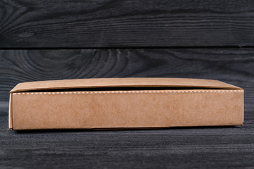 Small cardboard box on the wooden table