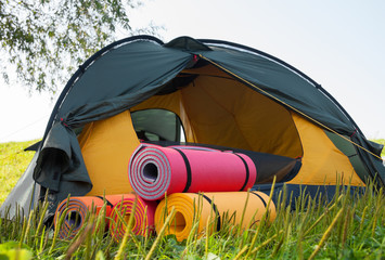 Open tent and rolled sleeping pads. © rootstocks