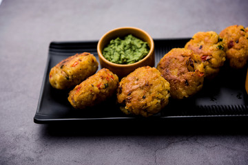 Veg Poha Cutlet or flattened Rice Patties served with tomato ketchup and green chutney