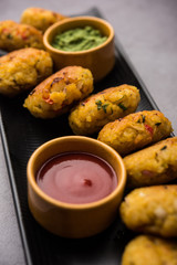 Veg Poha Cutlet or flattened Rice Patties served with tomato ketchup and green chutney