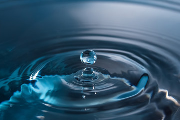 Splash of water close-up. Water drop. A blue drop of water. Falling water. The rain closeup.