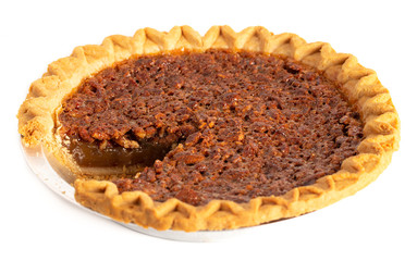 Traditional Pecan PIe with a Slice Cut Out on a White Background