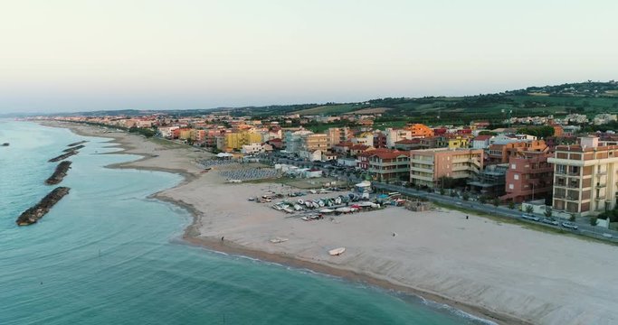 Italian beach and coastal city  during the sunset. Aerial view of Senigallia, Ancona, Le Marche, Italy by drone.