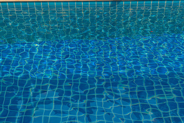 blue water in swimming pool beside the house.