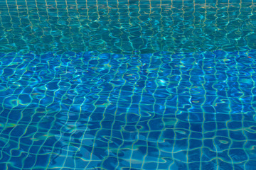 blue water in swimming pool beside the house.
