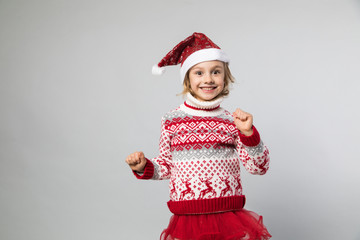 Smiling girl in the winter look on the grey