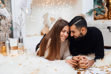 Adding some romance. Holiday romance of bearded man and sexy woman. Couple in love relaxing in the studio. Feeling romance. Love and romance. Christmas and New Year concept.