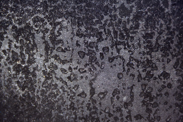 Frozen drops of water on glass, background