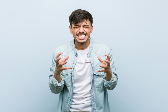 Young Hispanic Cool Man Upset Screaming With Tense Hands.