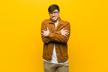 Young hispanic casual man going cold due to low temperature or a sickness.
