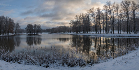 Snowy sunset park view at a pond on the Drottningholm island 