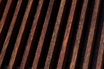 Abstract background in the form of diagonal lines of a wooden structure close-up.