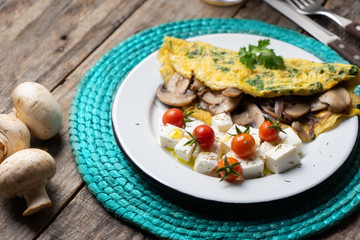 Mushroom omelette with fresh cheese and cherry tomatoes