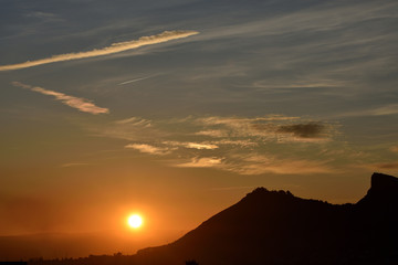 Nice sunset with the solar disk hiding along the horizon and the mountains of Sierra Elvira ahead
