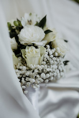 Close up of a bridal bouquet with white roses