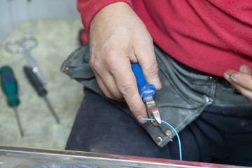 The electrician installs the lighting lamp in the office.