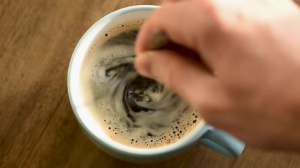Stirring black coffee with spoon. Morning coffee routine, cup of american black coffee or espresso