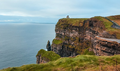 The Cliffs of Moher are sea cliffs next to O'Brien's Tower located at the southwestern edge of the...