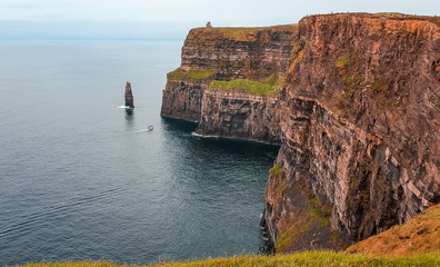 The Cliffs of Moher are sea cliffs next to O'Brien's Tower located at the southwestern edge of the Burren region in County Clare, Ireland.