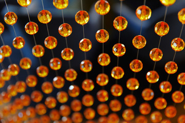 background of orange round beads on strings