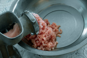 Vintage meat grinder and minced meat. The process of grinding meat in an old meat grinder