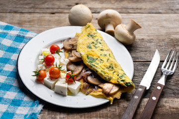 Mushroom omelette with fresh cheese and cherry tomatoes