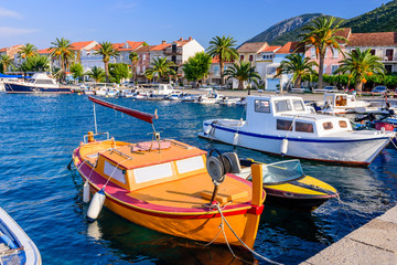 Fototapeta na wymiar Colorful fishing boats in the Harbor of Trpanj town, Peljesac Peninsula, Dalmatia region, Croatia. The picturesque coast of the Adriatic sea in Trpanj town