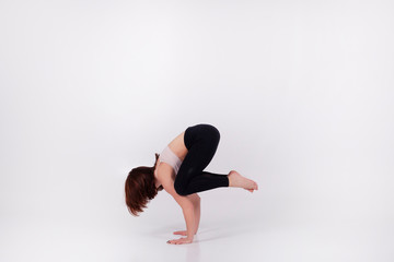 Young beautiful girl performs yoga exercises