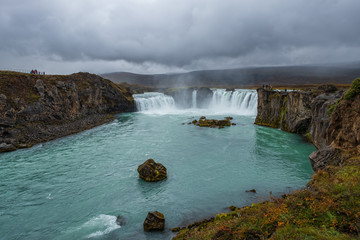 Fototapeta na wymiar landscape of the Godafoss famous waterfall in Iceland. The breathtaking landscape of Godafoss waterfall attracts tourist to visit the Northeastern Region of Iceland. September 2019