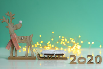 Christmas and New Year Decorate on green background,wooden numbers 2020 with bokeh New Year's...