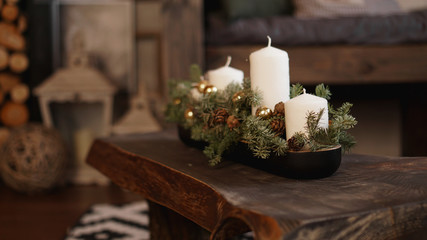 Christmas decoration on wooden background. Christmas white candles on a wooden table