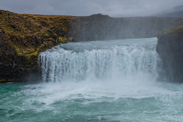 landscape of the Godafoss famous waterfall in Iceland. The breathtaking landscape of Godafoss waterfall attracts tourist to visit the Northeastern Region of Iceland. September 2019