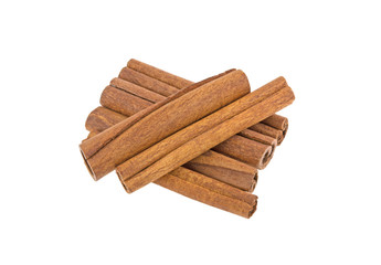 many cinnamon sticks on a white background isolated