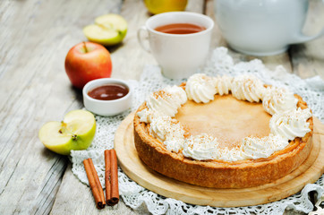 apple cake decorated with whipped cream and cinnamon