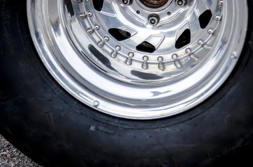 racing wheel. chrome wheel of a racing car. car racing concept. shabby racing tire