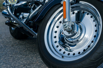road bike. view of the front chrome wheel of a motorcycle. cruiser. motorcycle concept