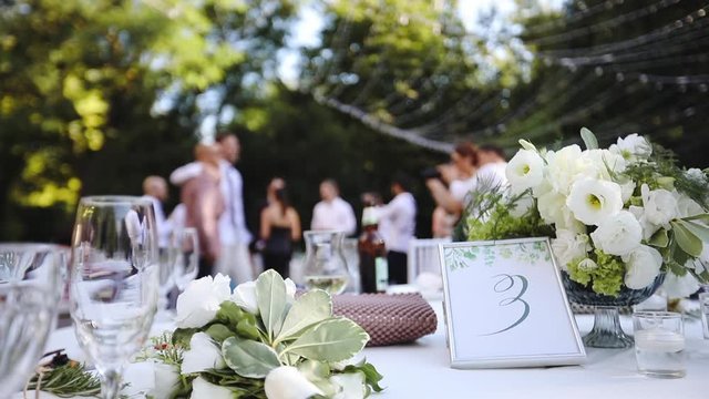Elegant wedding banquet table with at the restaurant&rsquo;s summer terrace