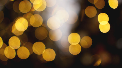 Defocused gold lights on the black background - Christmas time
