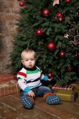 boy with gift near christmas tree