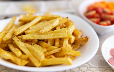at home, french fries. close-up of finely chopped fried potatoes on white plate