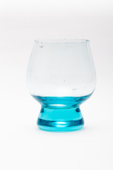 Broken blue wine glass on a white background